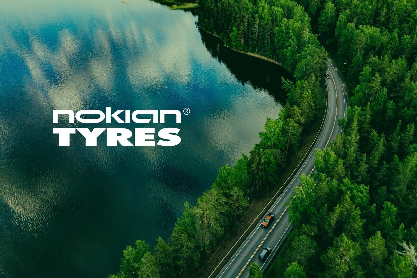 Ariel view of lake, woods and road with text "Nokian Tyres"
